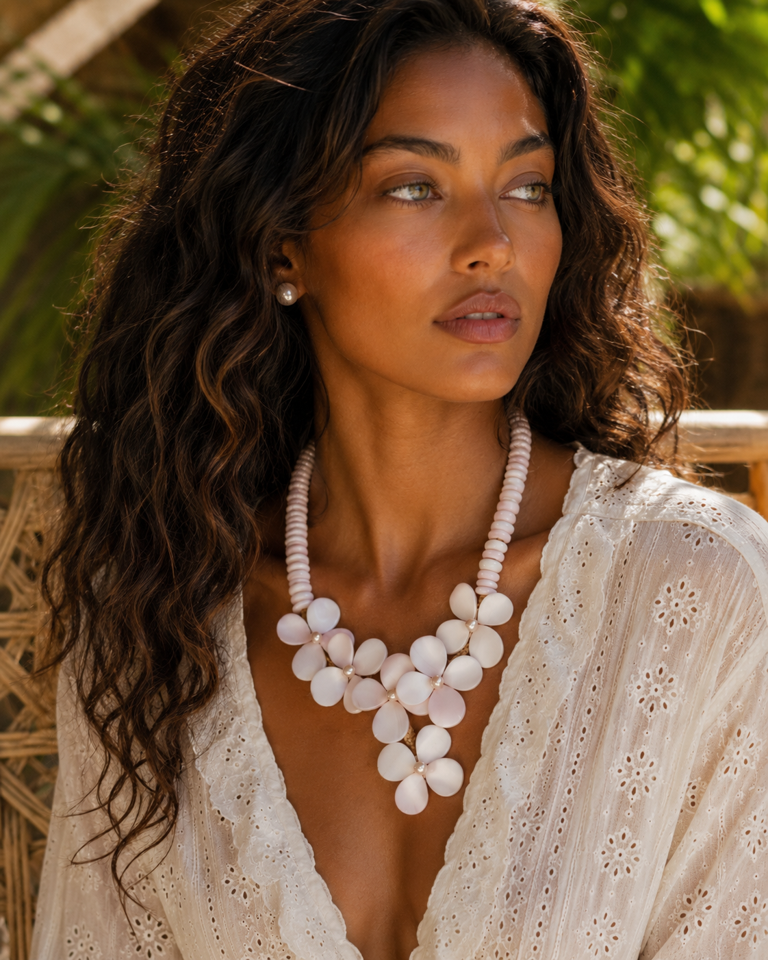 Model wearing the Flor del Mar conch shell and freshwater pearl necklace, showcasing its sculptural floral design and elegant statement silhouette.