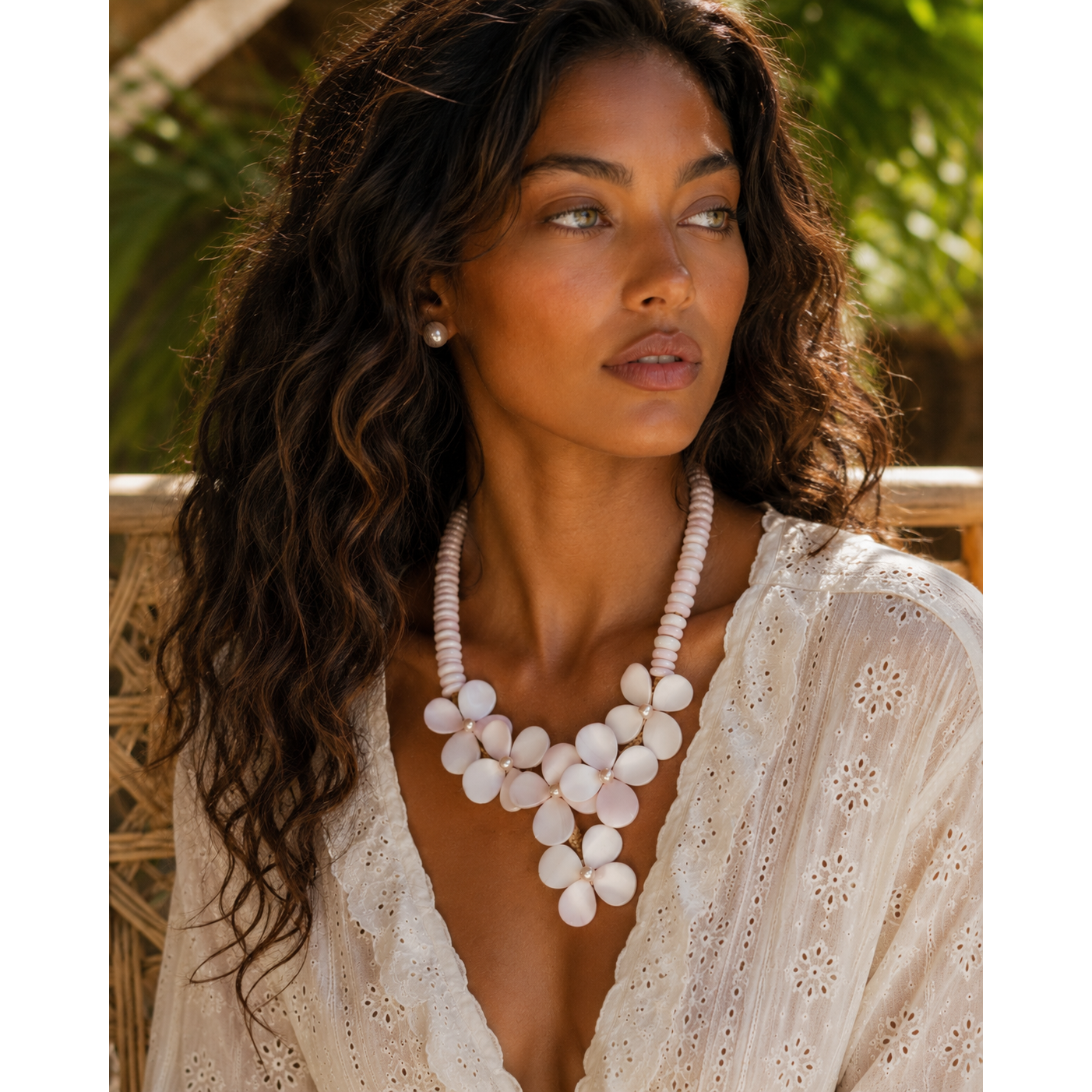Model wearing the Flor del Mar conch shell and freshwater pearl necklace, showcasing its sculptural floral design and elegant statement silhouette.