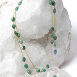 Fortuna Necklace styled as an elegant two-strand necklace, showcasing natural emerald gemstones on a gold-plated chain with versatile styling and timeless elegance.