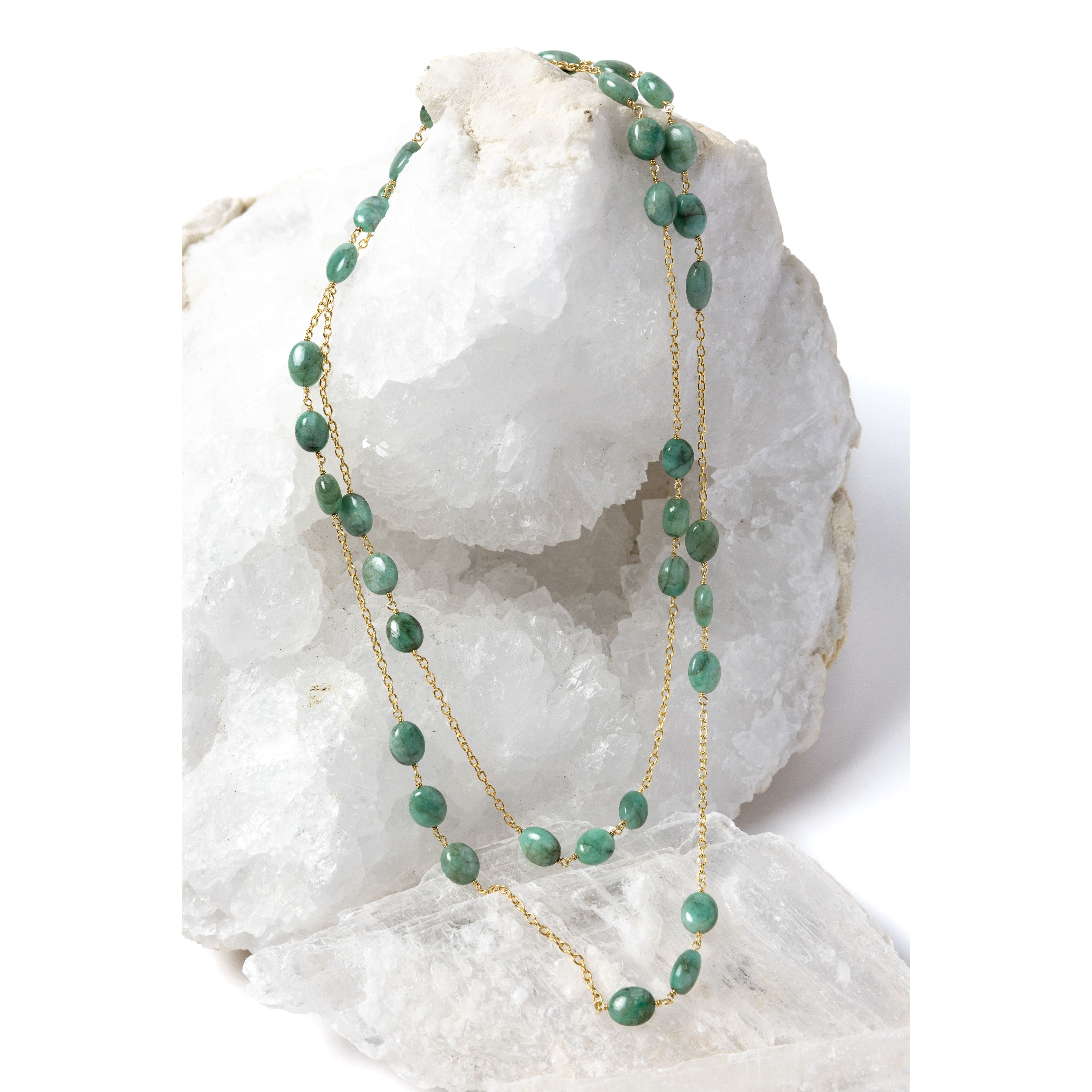 Fortuna Necklace styled as an elegant two-strand necklace, showcasing natural emerald gemstones on a gold-plated chain with versatile styling and timeless elegance.