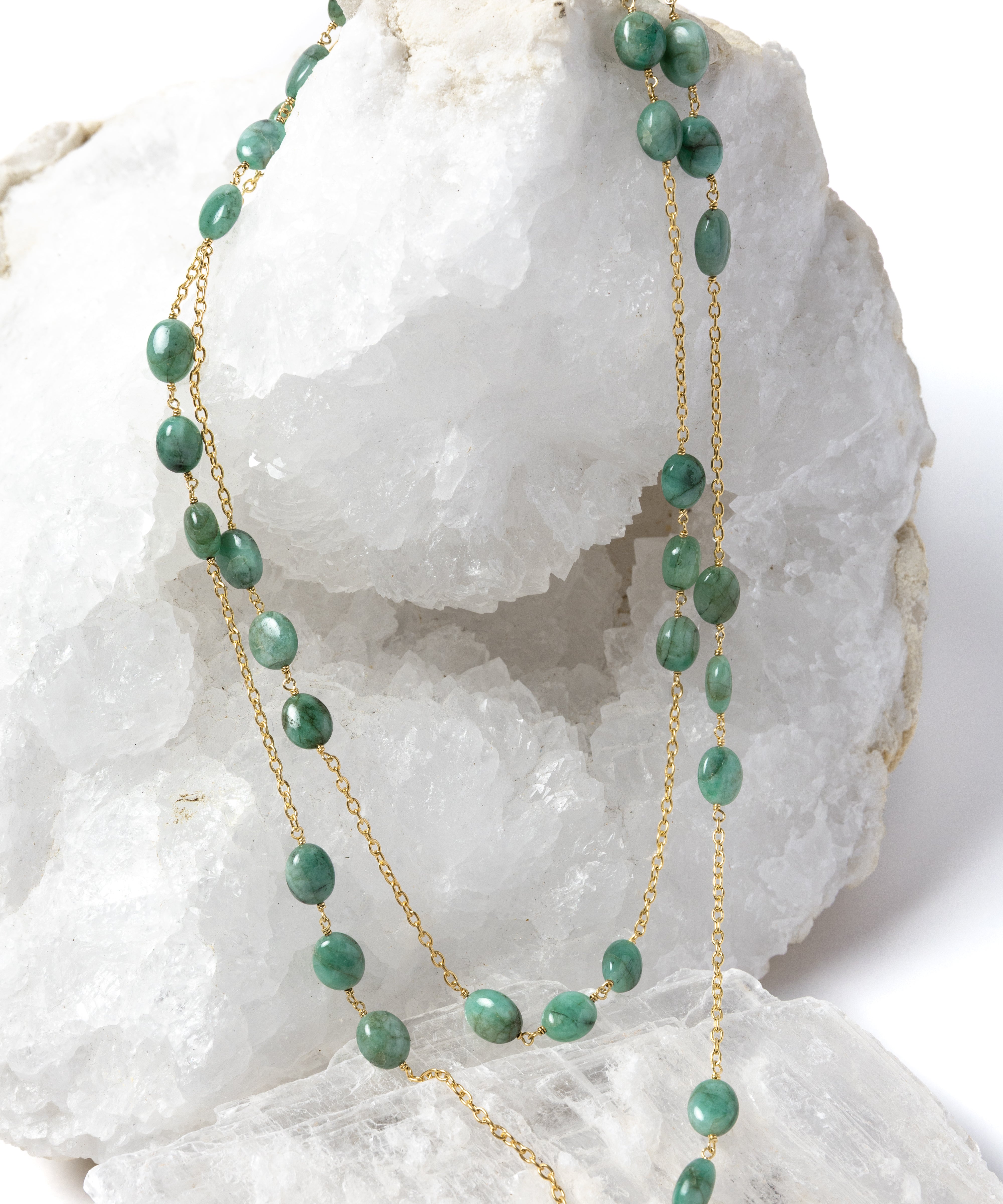 Fortuna Necklace styled as an elegant two-strand necklace, showcasing natural emerald gemstones on a gold-plated chain with versatile styling and timeless elegance.