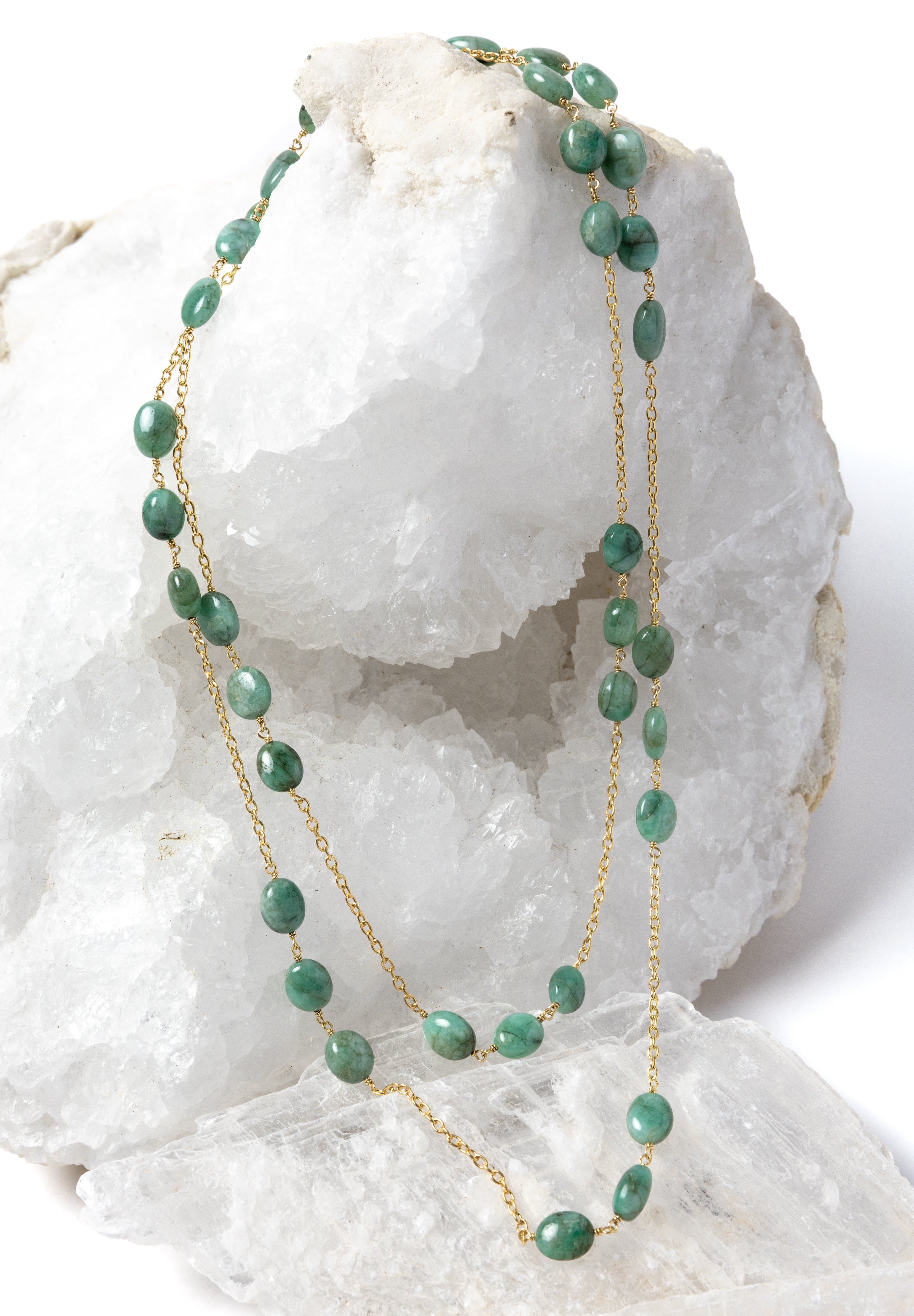 Fortuna Necklace styled as an elegant two-strand necklace, showcasing natural emerald gemstones on a gold-plated chain with versatile styling and timeless elegance.