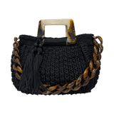 Black hand-crocheted Giselle handbag featuring a tortoiseshell resin handle, coordinating resin chain, and textured crochet body