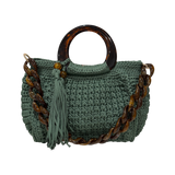 Green hand-crocheted Giselle handbag with tortoiseshell resin handle, coordinating resin chain, and tassel detail