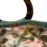 Tropical botanical lining inside the Giselle Bag Emerald Oasis featuring lush foliage motifs and natural-inspired details