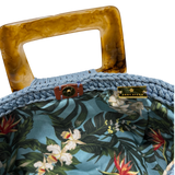Tropical botanical lining inside the Giselle handbag featuring birds of paradise flowers and lush foliage on a blue background
