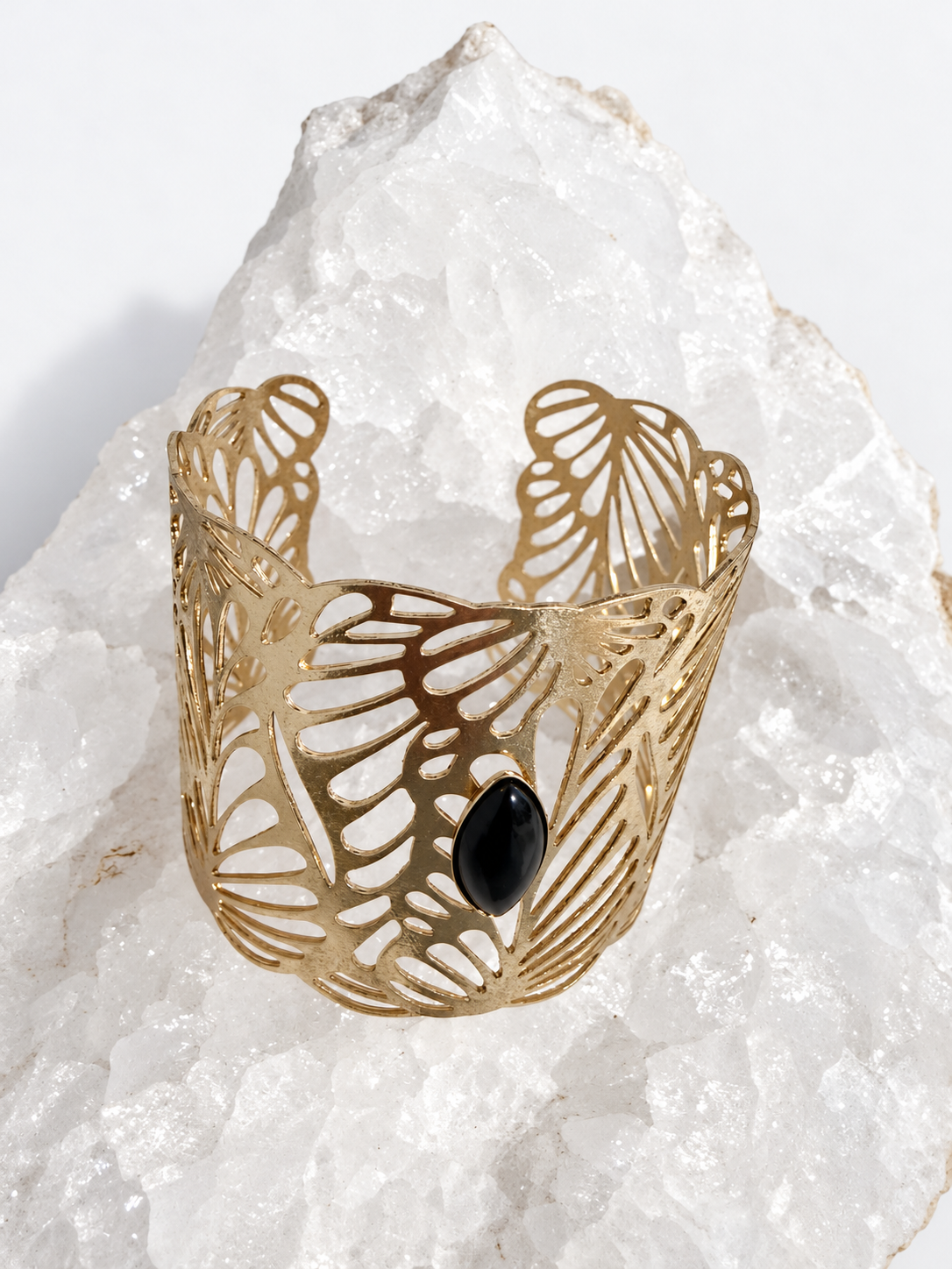 Wide gold-plated Golden Palm cuff bracelet with an intricate lace-like openwork design and a 15 × 7 mm natural black onyx navette cabochon at the center.
