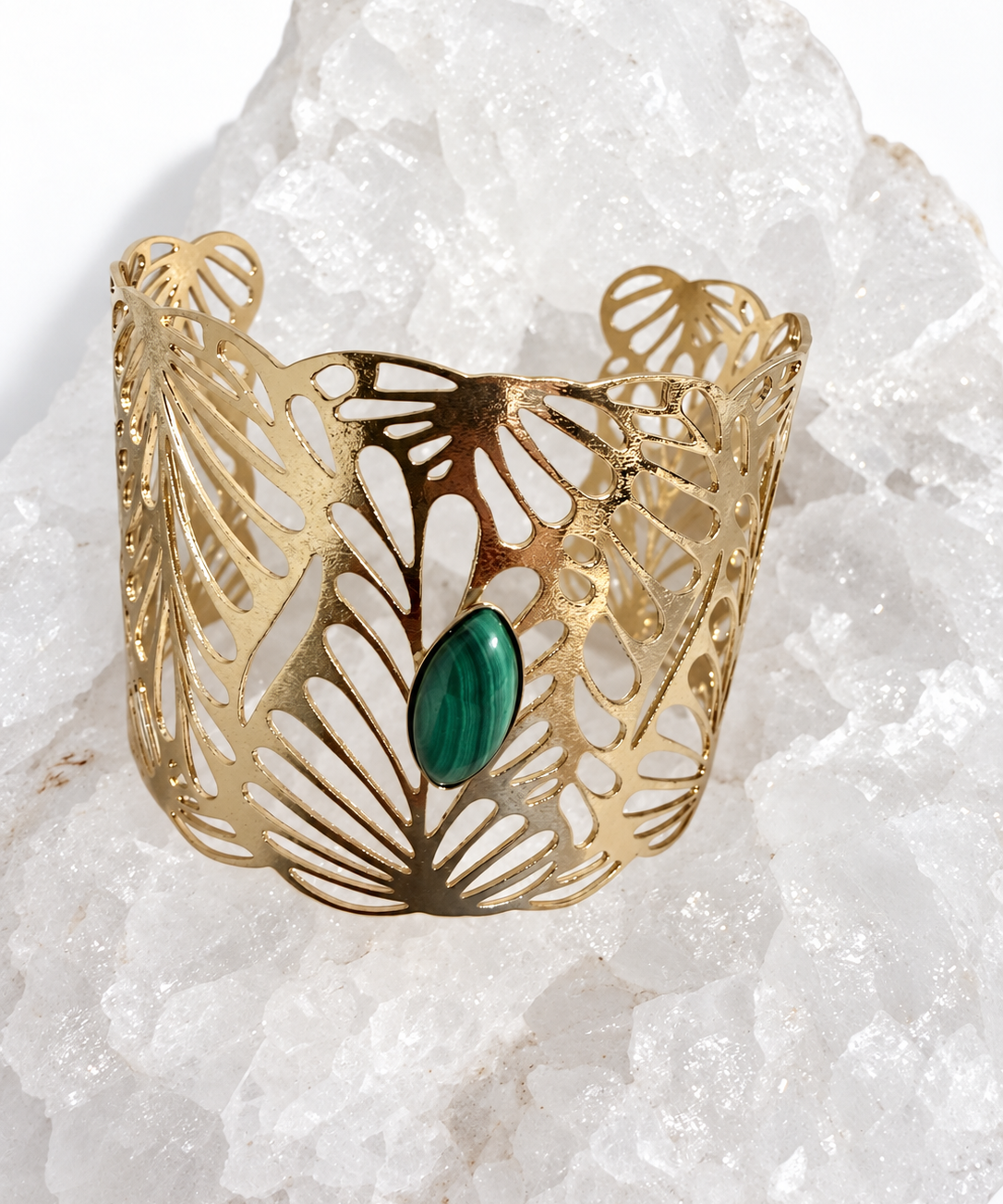 Wide gold-plated Golden Palm cuff bracelet with an intricate lace-like openwork design and a 15 × 7 mm natural malachite navette cabochon at the center.