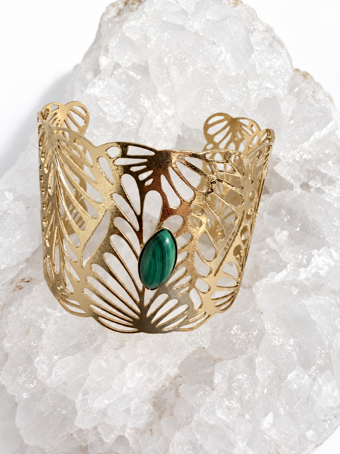 Wide gold-plated Golden Palm cuff bracelet with an intricate lace-like openwork design and a 15 × 7 mm natural malachite navette cabochon at the center.