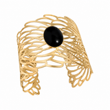 Golden Symphony Cuff featuring an 18 × 13 mm oval black onyx cabochon surrounded by sweeping golden curves and intricate openwork detailing.