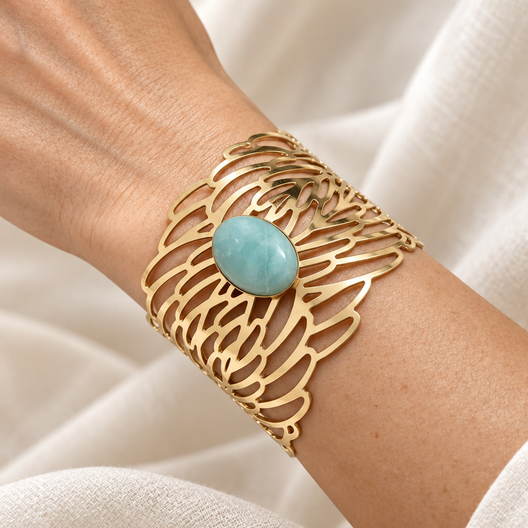Golden Symphony statement cuff worn on the wrist, showcasing its wide sculptural silhouette, flowing golden openwork, and elegant fit.