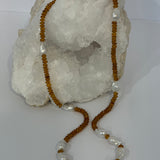 Golden Velvet Necklace a 33-inch necklace with deep golden natural citrine rondelles and luminous baroque pearls arranged throughout the long strand.