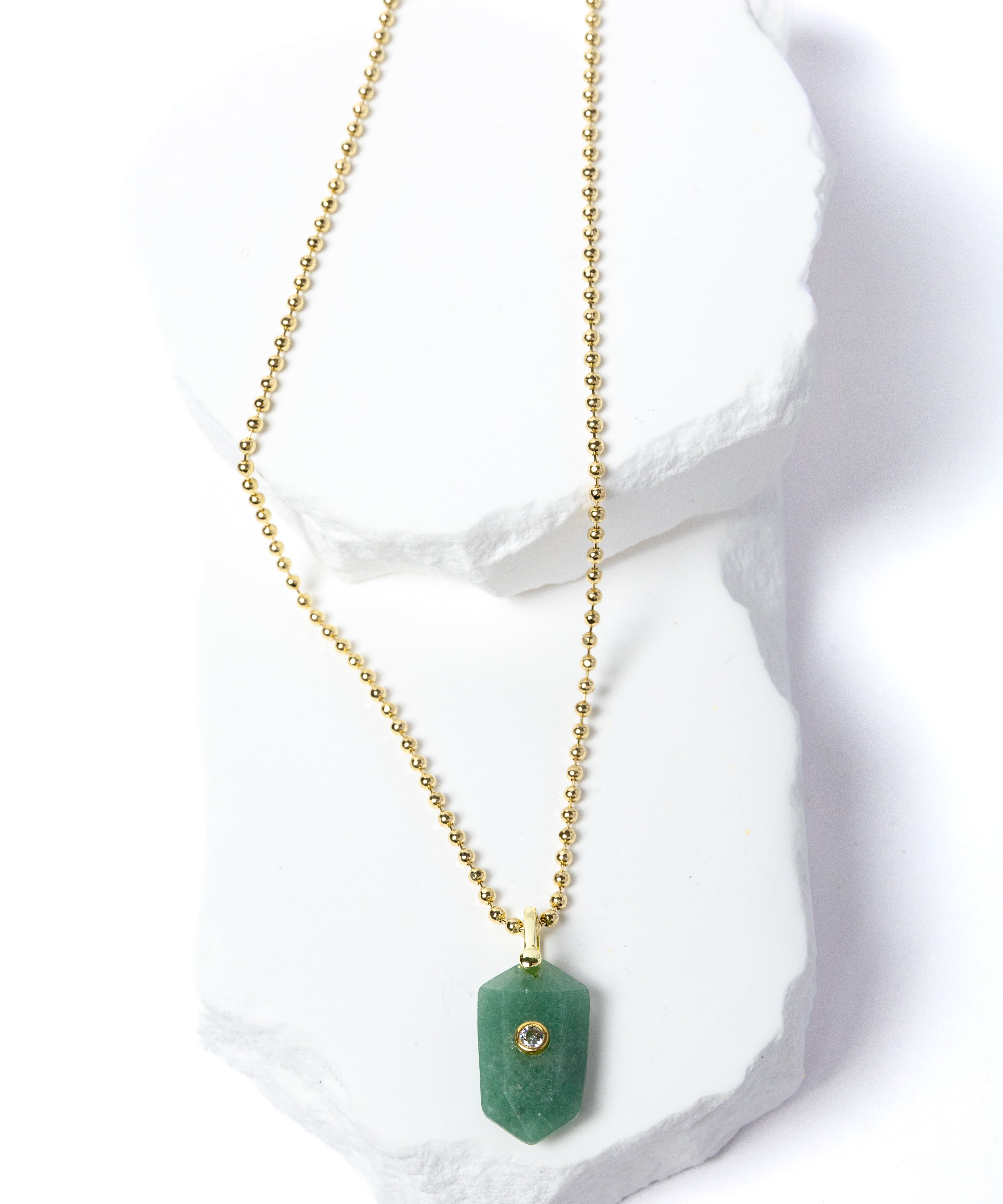 Green Aventurine Gem Charm Necklace featuring a faceted natural green aventurine pendant accented with a cubic zirconia detail and suspended from a delicate gold-plated beaded chain 