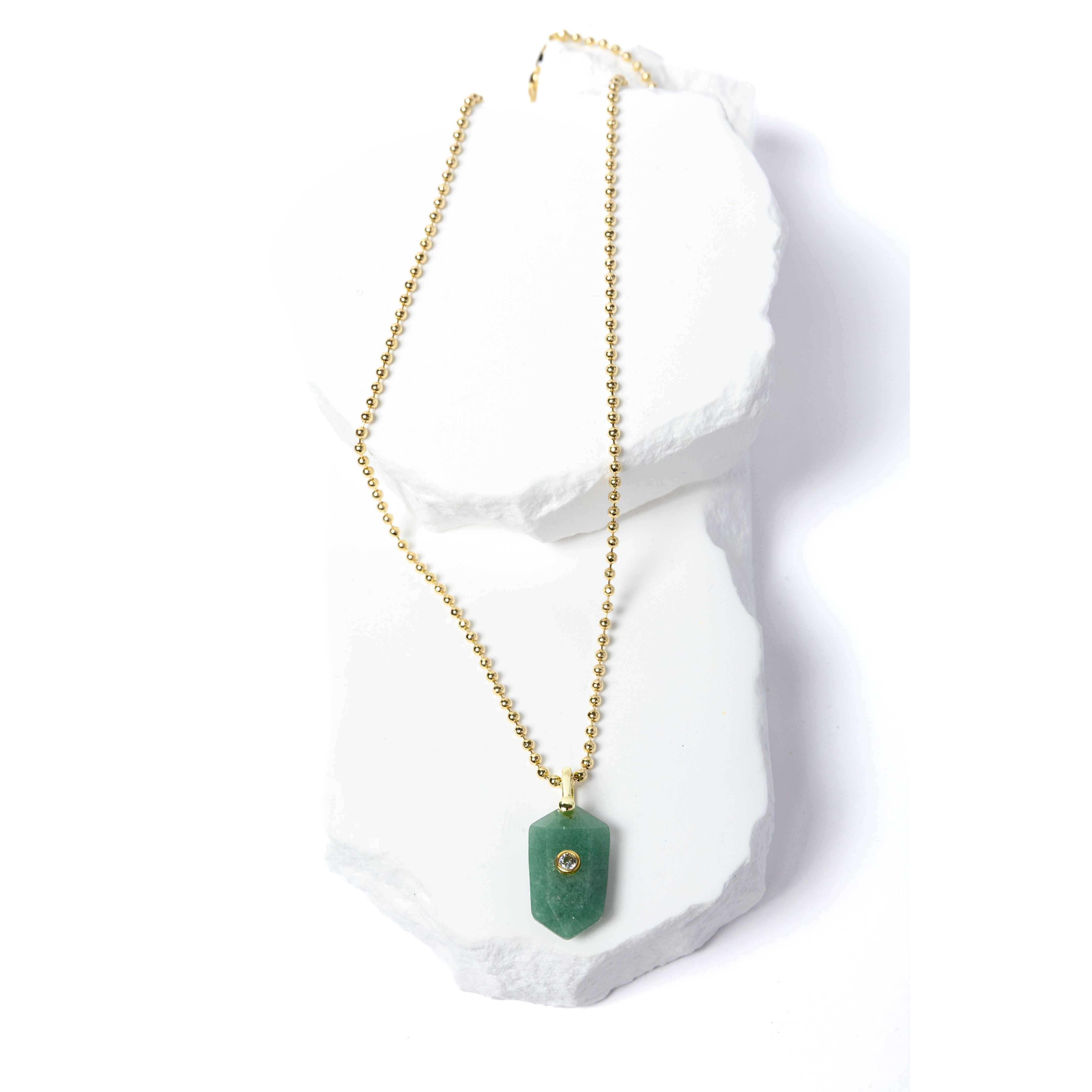 Green Aventurine Gem Charm Necklace featuring a faceted natural green aventurine pendant accented with a cubic zirconia detail and suspended from a delicate gold-plated beaded chain 