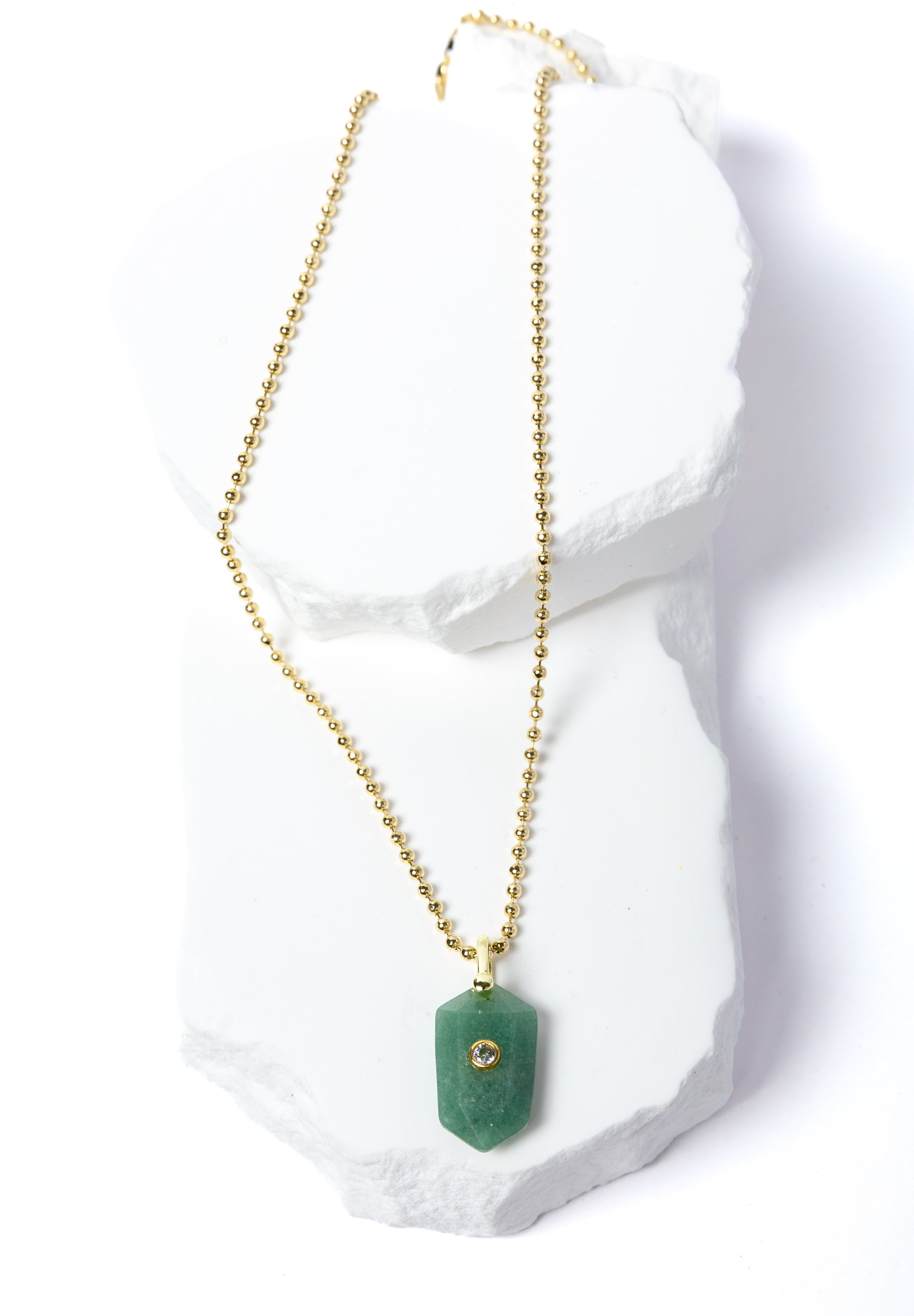 Green Aventurine Gem Charm Necklace featuring a faceted natural green aventurine pendant accented with a cubic zirconia detail and suspended from a delicate gold-plated beaded chain 
