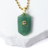 Close-up of a faceted Green Aventurine pendant showcasing its soft botanical green color, natural stone character, cubic zirconia accent, and gold-plated setting.
