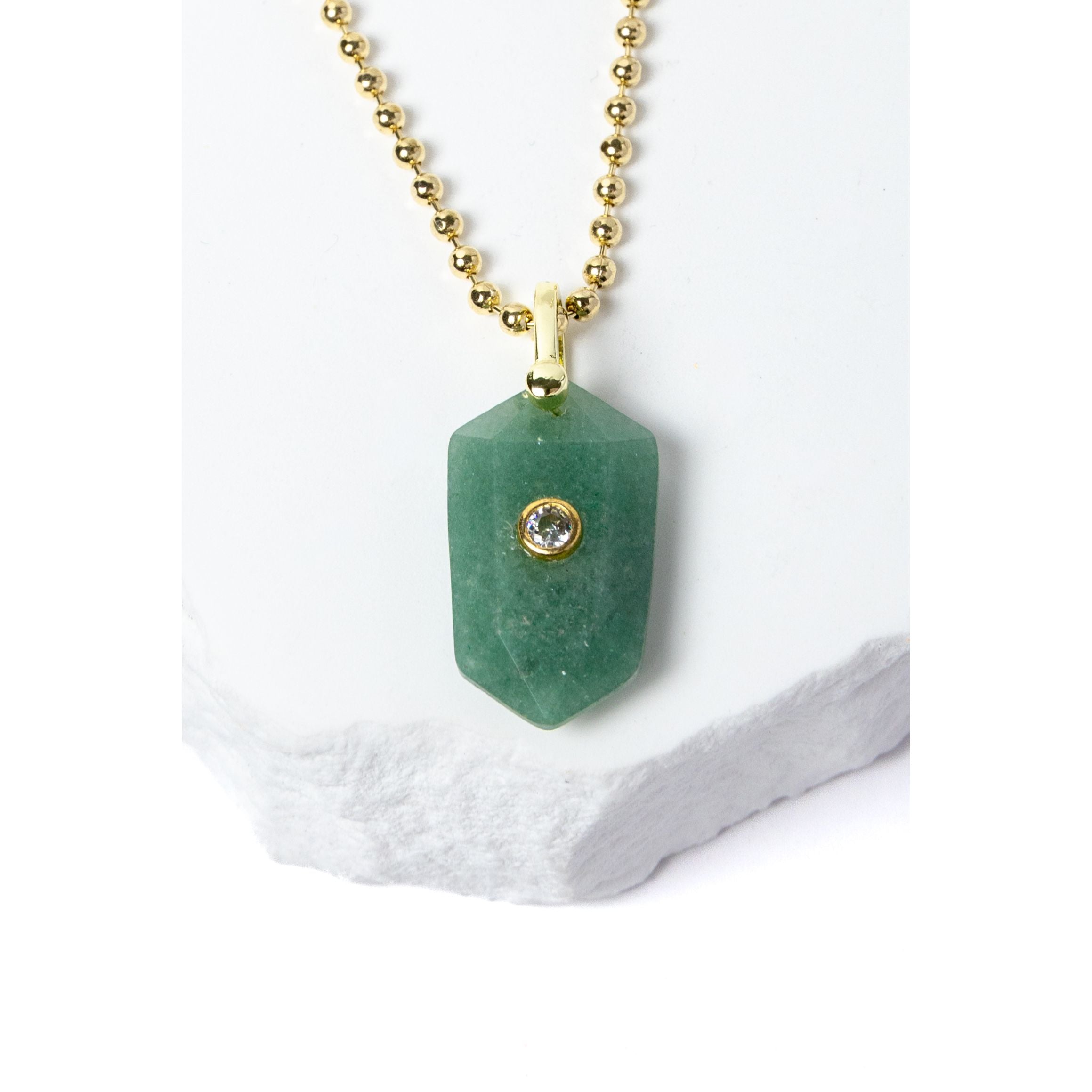 Close-up of a faceted Green Aventurine pendant showcasing its soft botanical green color, natural stone character, cubic zirconia accent, and gold-plated setting.