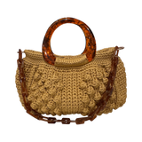 Paloma Bloomfield handbag, hand-crocheted luxury bag in warm golden tone with sculptural resin handle, textured crochet detail and chain strap