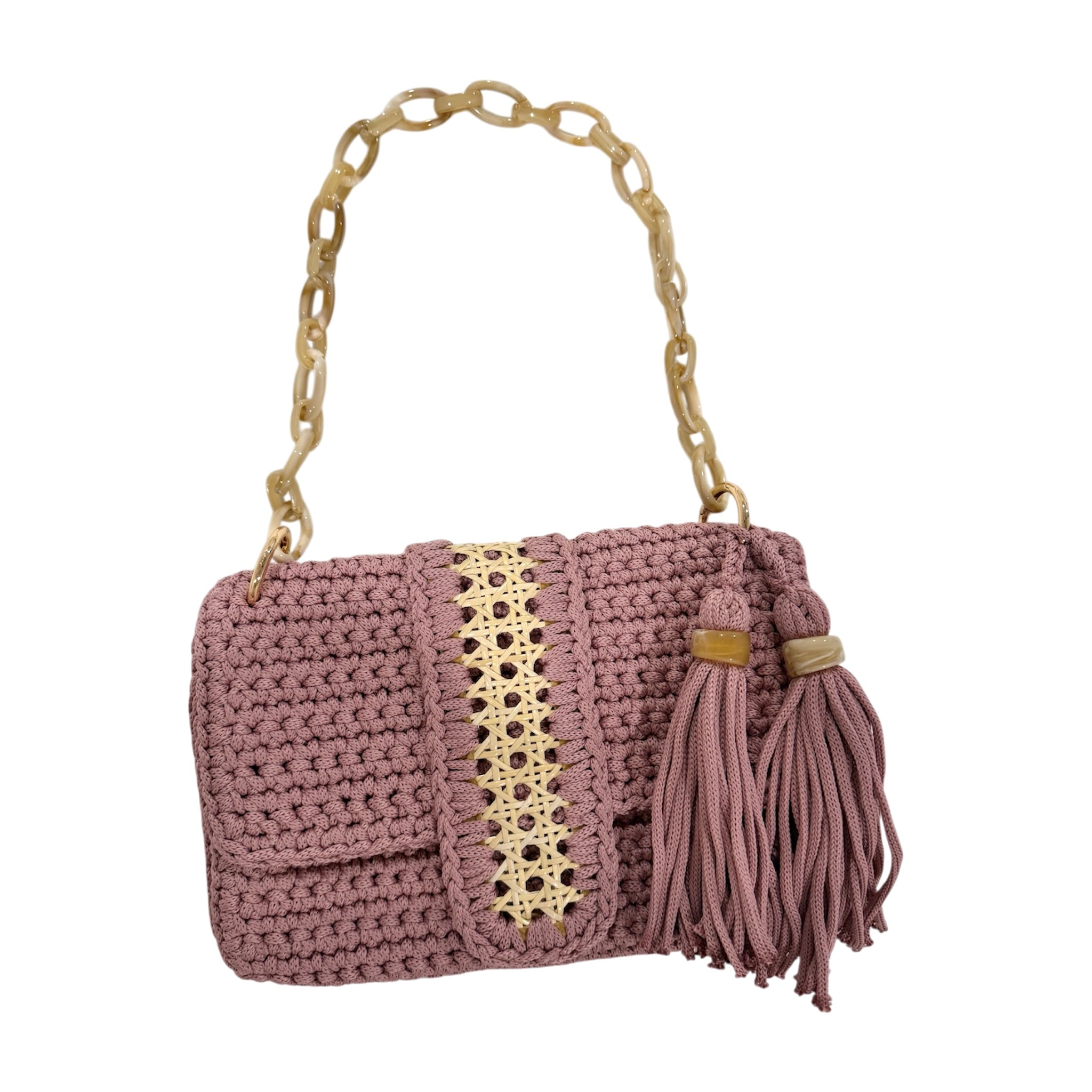 Blush hand-crocheted Camille clutch with natural fiber rattan center panel, gold-tone accent, and tassel