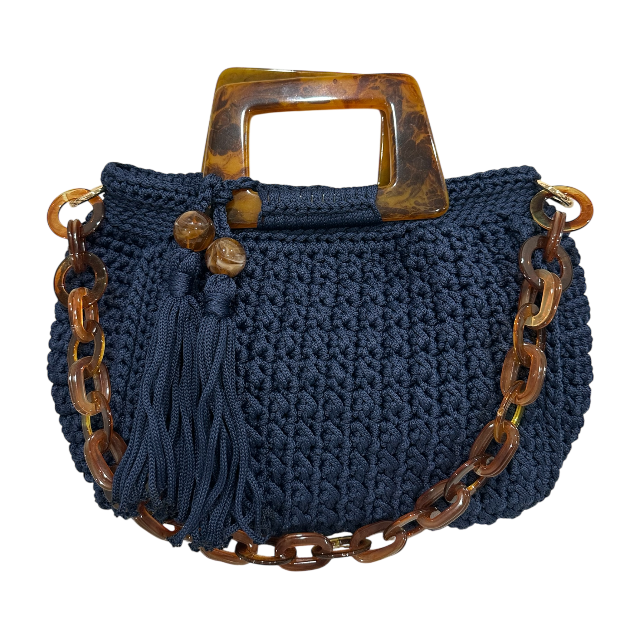 Hand-crocheted Giselle handbag in a deep midnight indigo tone with dimensional textured stitching, featuring marbled resin round handles, a coordinating chain strap, and tassel accents with polished bead details.