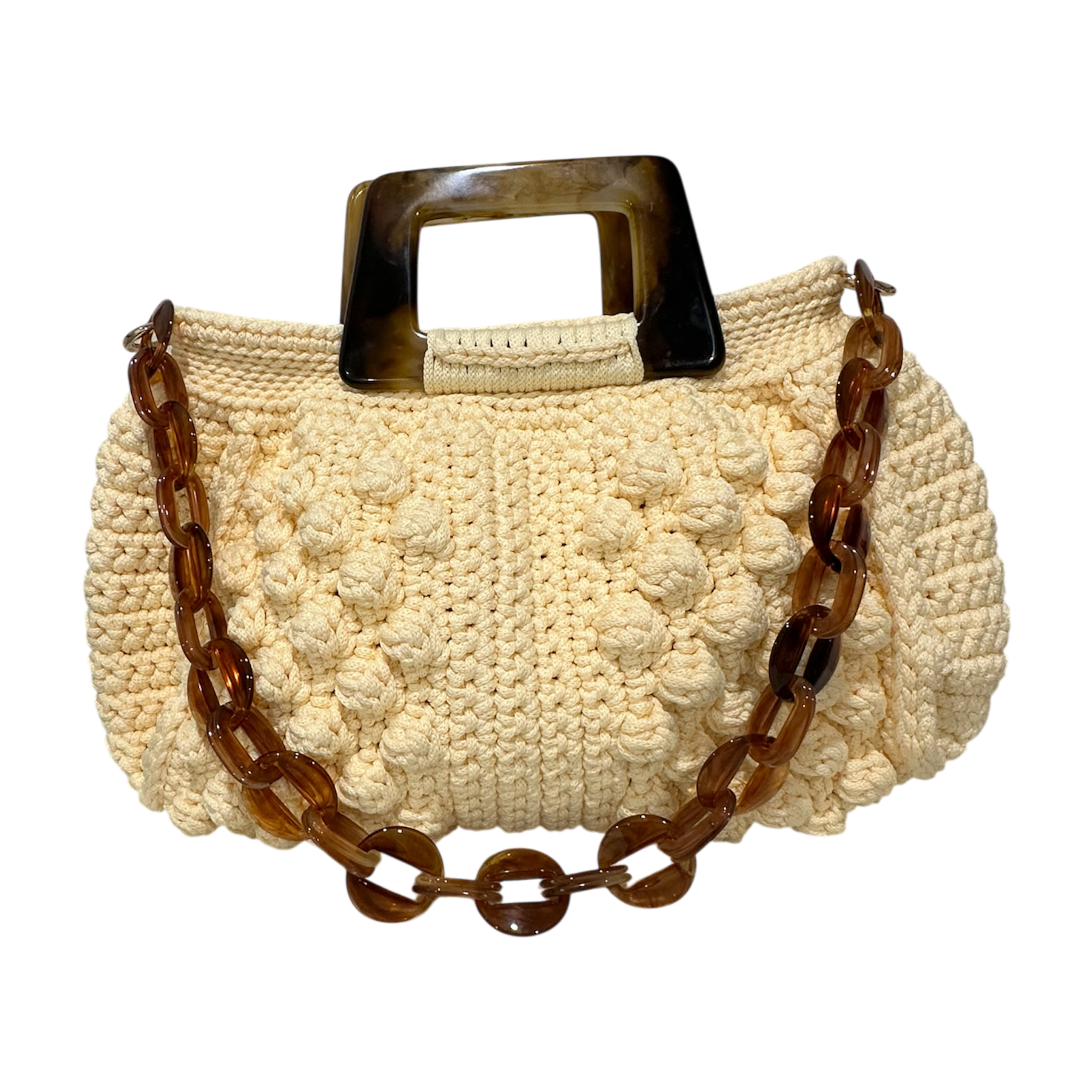 Hand-crocheted Paloma handbag in a soft pale yellow tone with richly textured stitching, featuring a sculptural marbled resin top handle and a coordinating resin chain strap.
