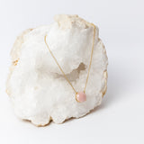 Luna Necklace featuring a luminous 20mm round rose quartz cabochon in a delicate gold-plated setting, suspended from a fine 18k gold-plated chain.