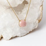 Close-up of Luna Necklace highlighting the luminous 20mm round rose quartz cabochon, its soft blush pink tones, and the delicate gold-plated setting.