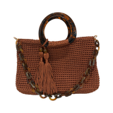 Copper hand-crocheted Monique handbag featuring a rounded marbled resin handle, coordinating resin-link chain, and twin tassel details.