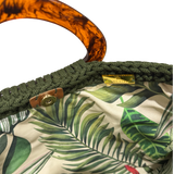 Interior of the Monique handbag in deep olive green featuring a palm-inspired botanical lining and magnetic snap closure.