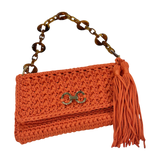 Orange hand-crocheted Polly clutch with gold-tone front detail, tassel, and resin chain