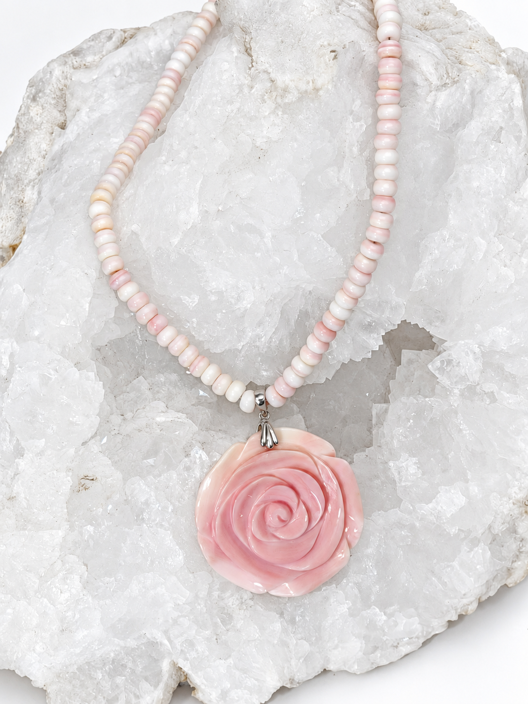 Handcrafted natural conch shell necklace with blush ivory and pink rondelles and a 4.5 cm hand-carved conch shell rose centerpiece, 18 inches with a 2-inch extension.