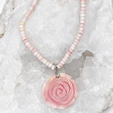Handcrafted natural conch shell necklace with blush ivory and pink rondelles and a 4.5 cm hand-carved conch shell rose centerpiece, 18 inches with a 2-inch extension.