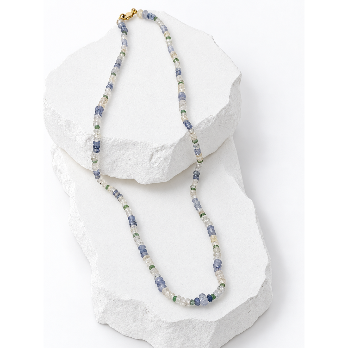  49-carat natural multicolor sapphire and emerald necklace featuring luminous pale blue, clear and soft green gemstones with a 14K gold clasp.