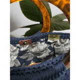 Interior view of the Paloma handbag · Sapphire Shadow, featuring a bold floral lining in navy and soft grey tones, framed by the structured crochet body and finished with refined resin handle details.
