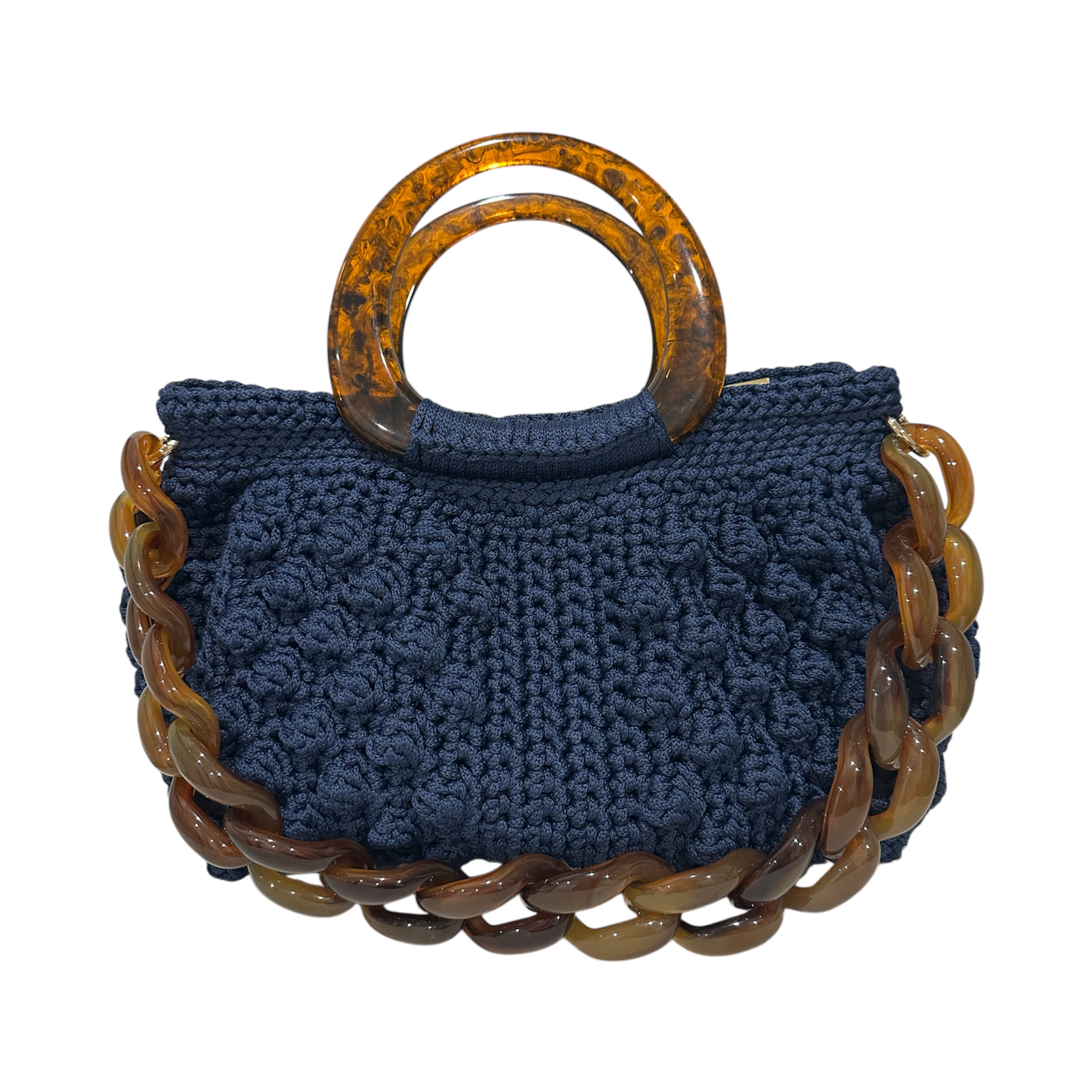 Hand-crocheted Paloma handbag in a deep sapphire blue tone with dimensional textured stitching, featuring a marbled resin top handle and a coordinating chain strap.