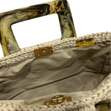 Interior view of the Paloma handbag · Stone Veil, showing a solid beige lining, framed by the softly structured crochet body and finished with refined resin handle details.