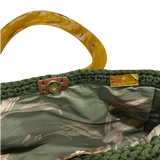 Interior view of the Giselle handbag · Orangery, showing a botanical-patterned lining in green and neutral tones