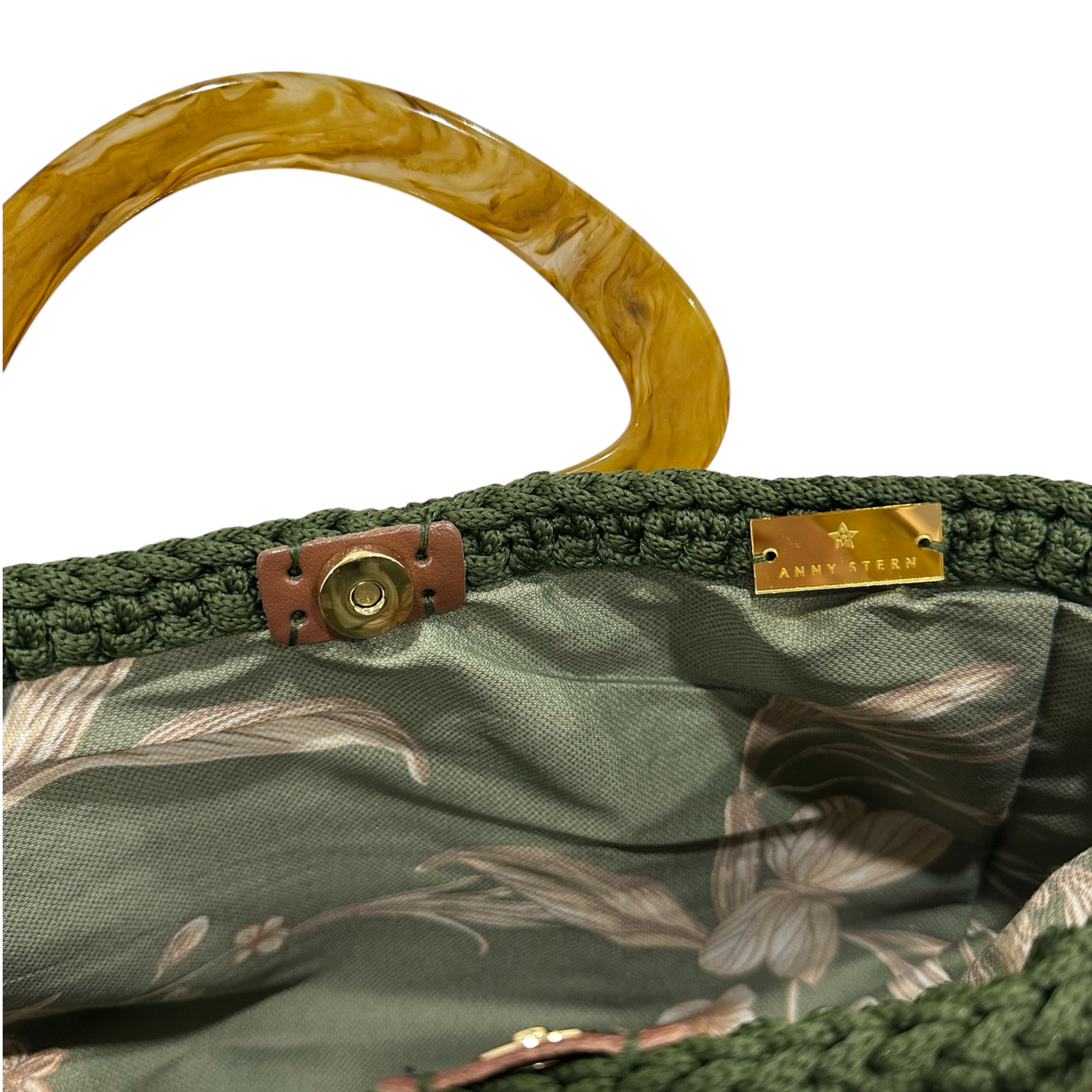 Interior view of the Giselle handbag · Orangery, showing a botanical-patterned lining in green and neutral tones