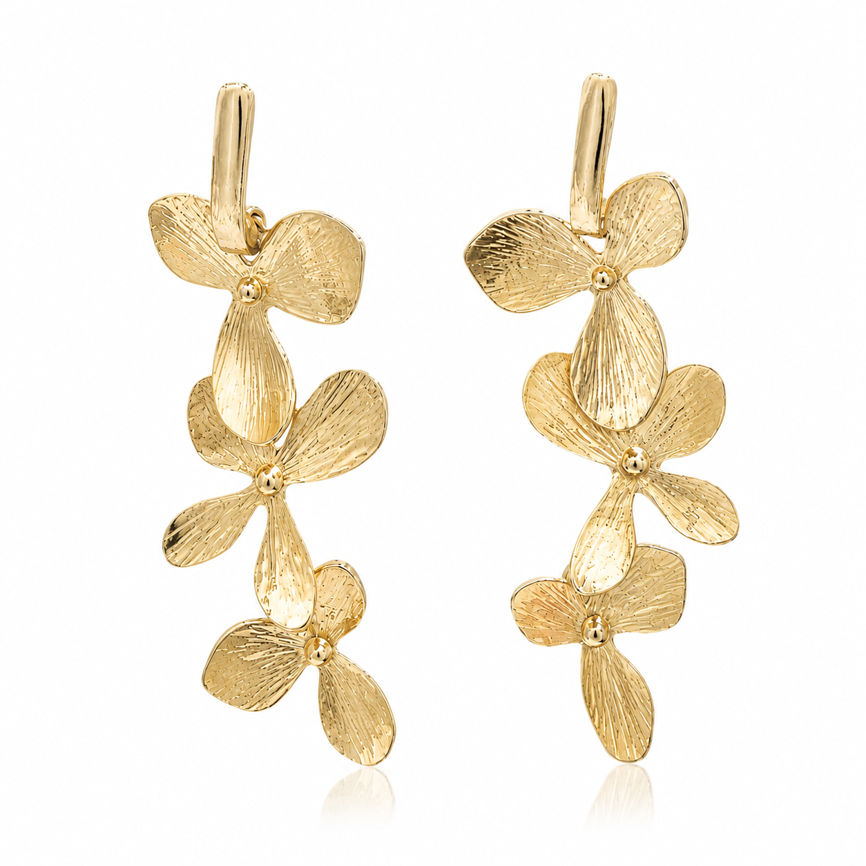 Orchid Cascade gold-plated statement earrings featuring three cascading sculptural orchid flowers with textured petals and a 2.5-inch drop.