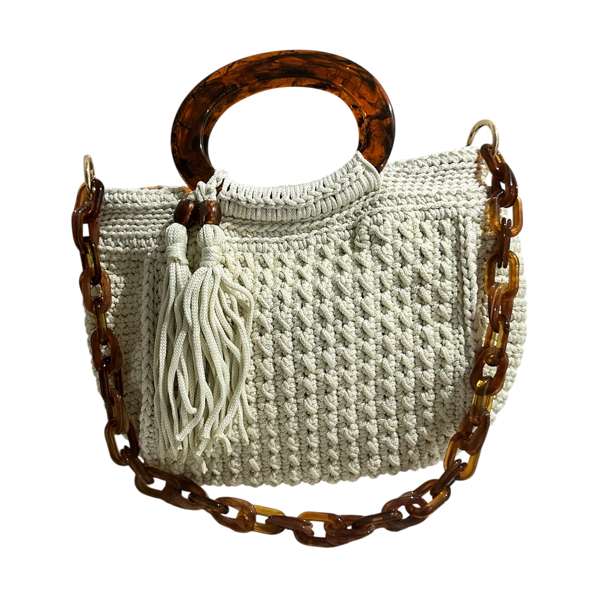 Off-white hand-crocheted Giselle handbag with tortoiseshell resin handle, coordinating chain strap, and tassel with tone-on-tone bead accents, featuring a neutral foliage lining.