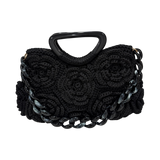Black hand-crocheted Paris handbag featuring sculptural rosette detailing, black resin handle, and marbled black resin chain with subtle gray and white accents