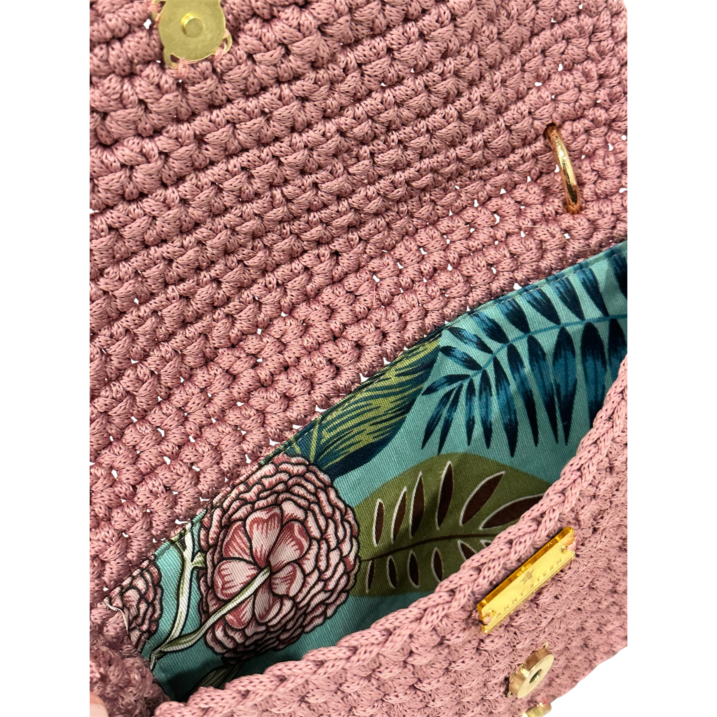 Interior of Camille Clutch with vibrant botanical floral lining in pink, green, and blue tones and secure closure