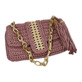 Close-up of natural fiber rattan panel on blush Camille clutch with crochet texture