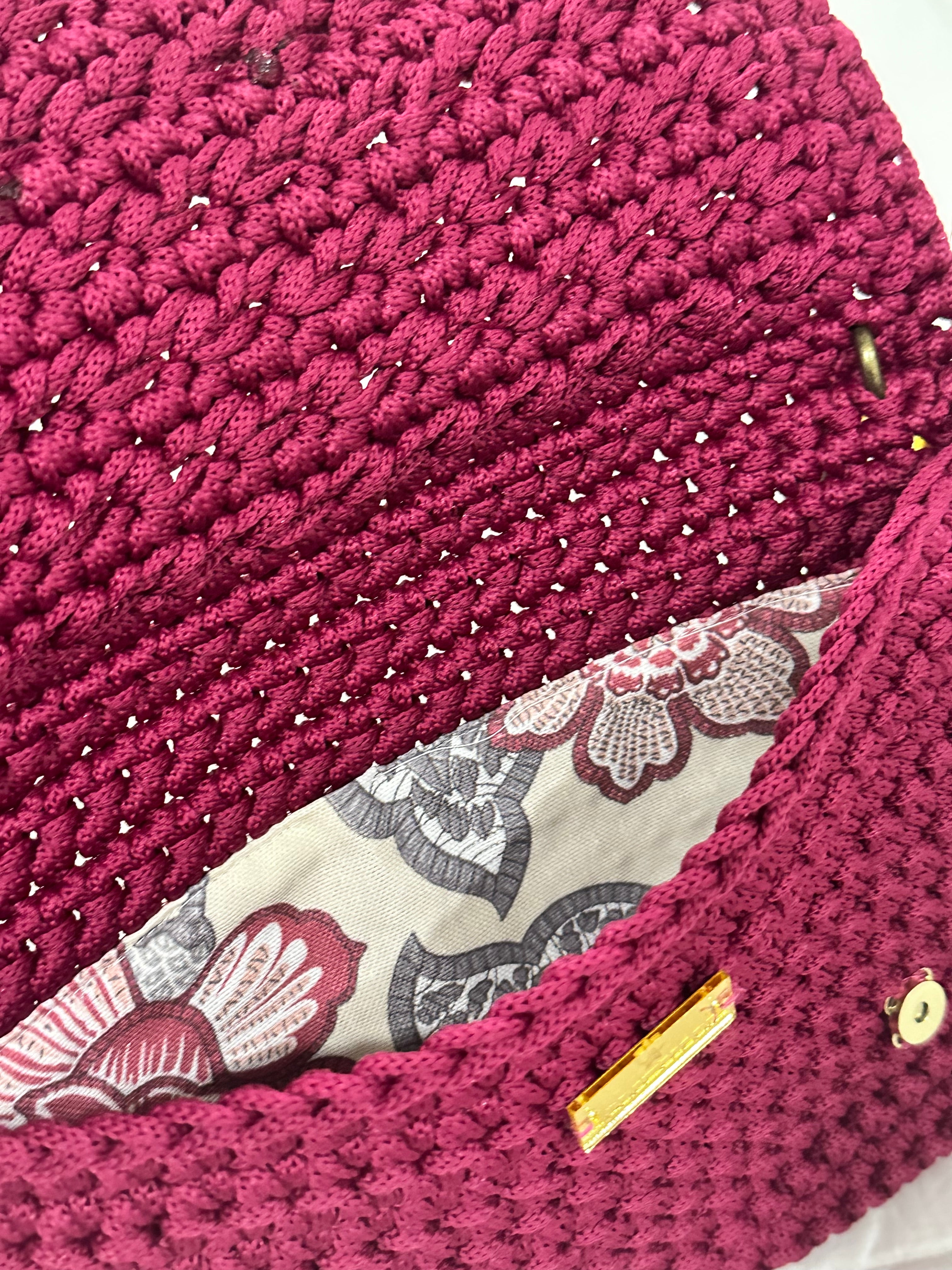 Botanical floral lining inside the Polly Clutch Mulberry Reserve featuring vibrant botanical motifs, magnetic closure, and handcrafted crochet construction