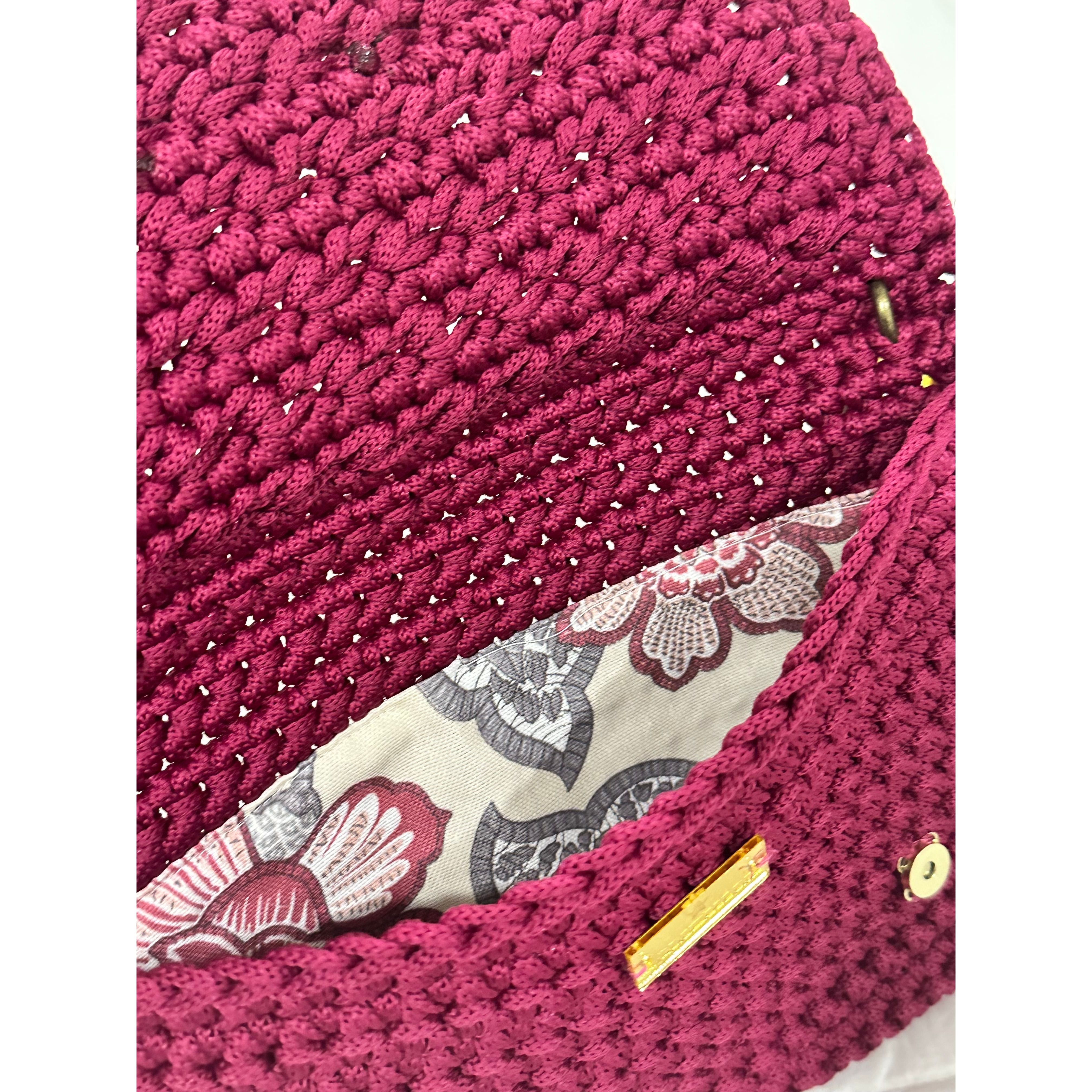 Botanical floral lining inside the Polly Clutch Mulberry Reserve featuring vibrant botanical motifs, magnetic closure, and handcrafted crochet construction