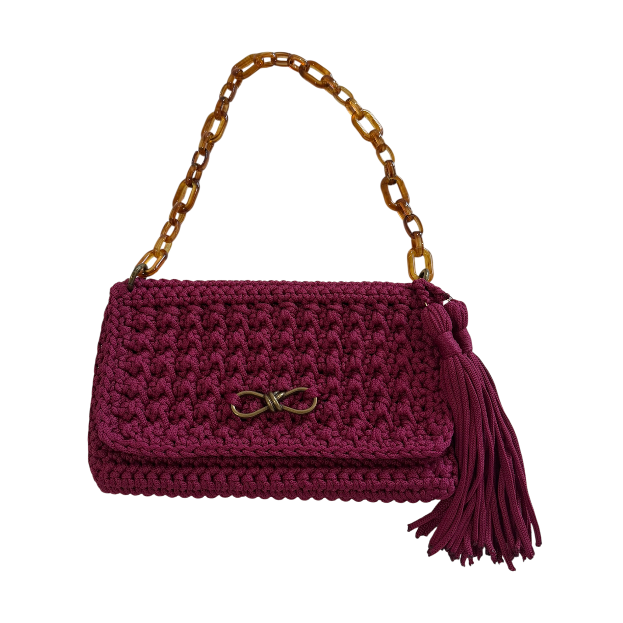 Magenta hand-crocheted Polly Clutch Mulberry Reserve featuring a resin chain strap, bronze hardware, decorative front accent, tassel detail, and textured crochet finish