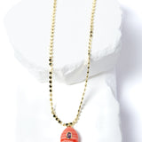 Gem Charm Necklace featuring a genuine rhodochrosite pendant with natural coral-pink banding, cubic zirconia accent, and gold-plated beaded chain.