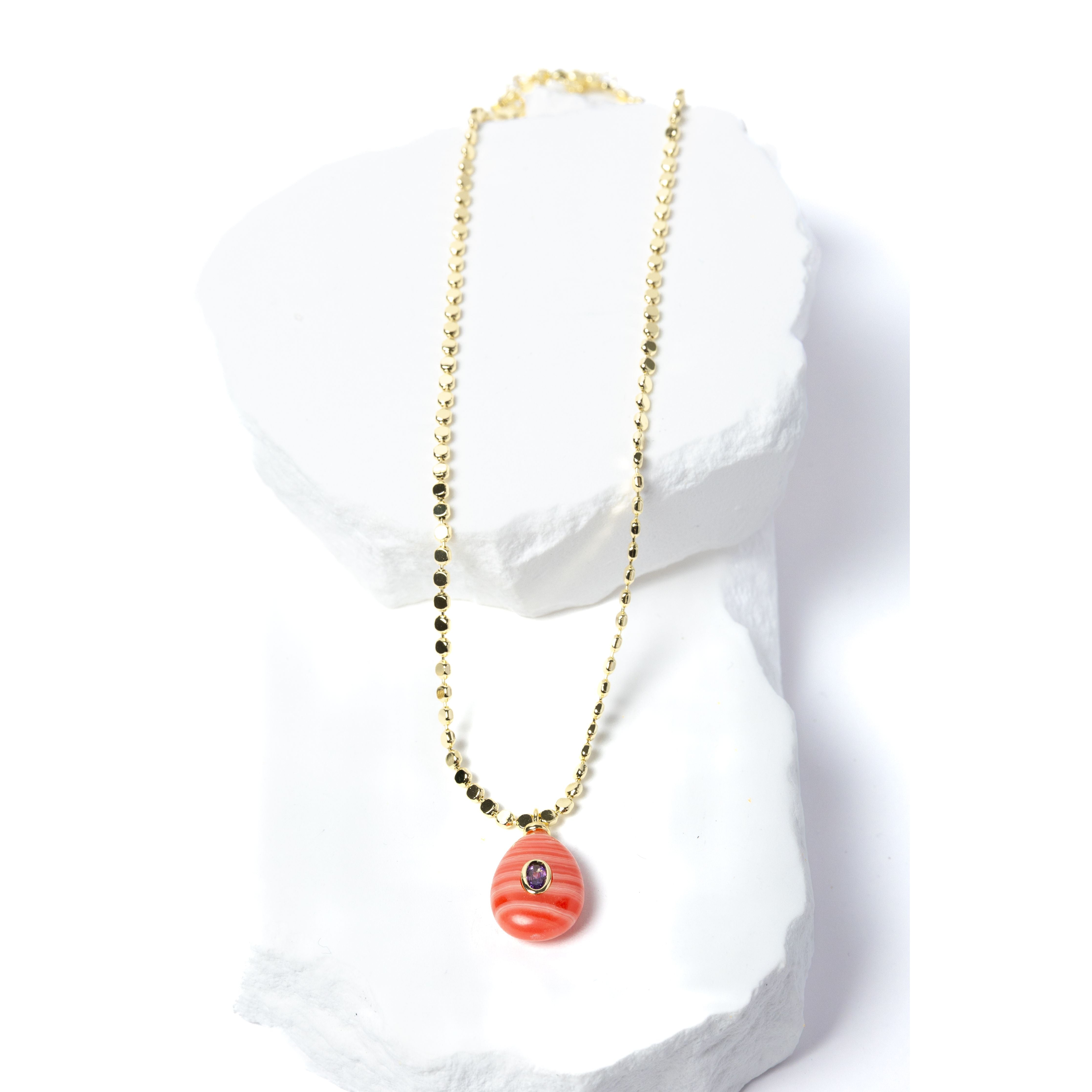 Gem Charm Necklace featuring a genuine rhodochrosite pendant with natural coral-pink banding, cubic zirconia accent, and gold-plated beaded chain.