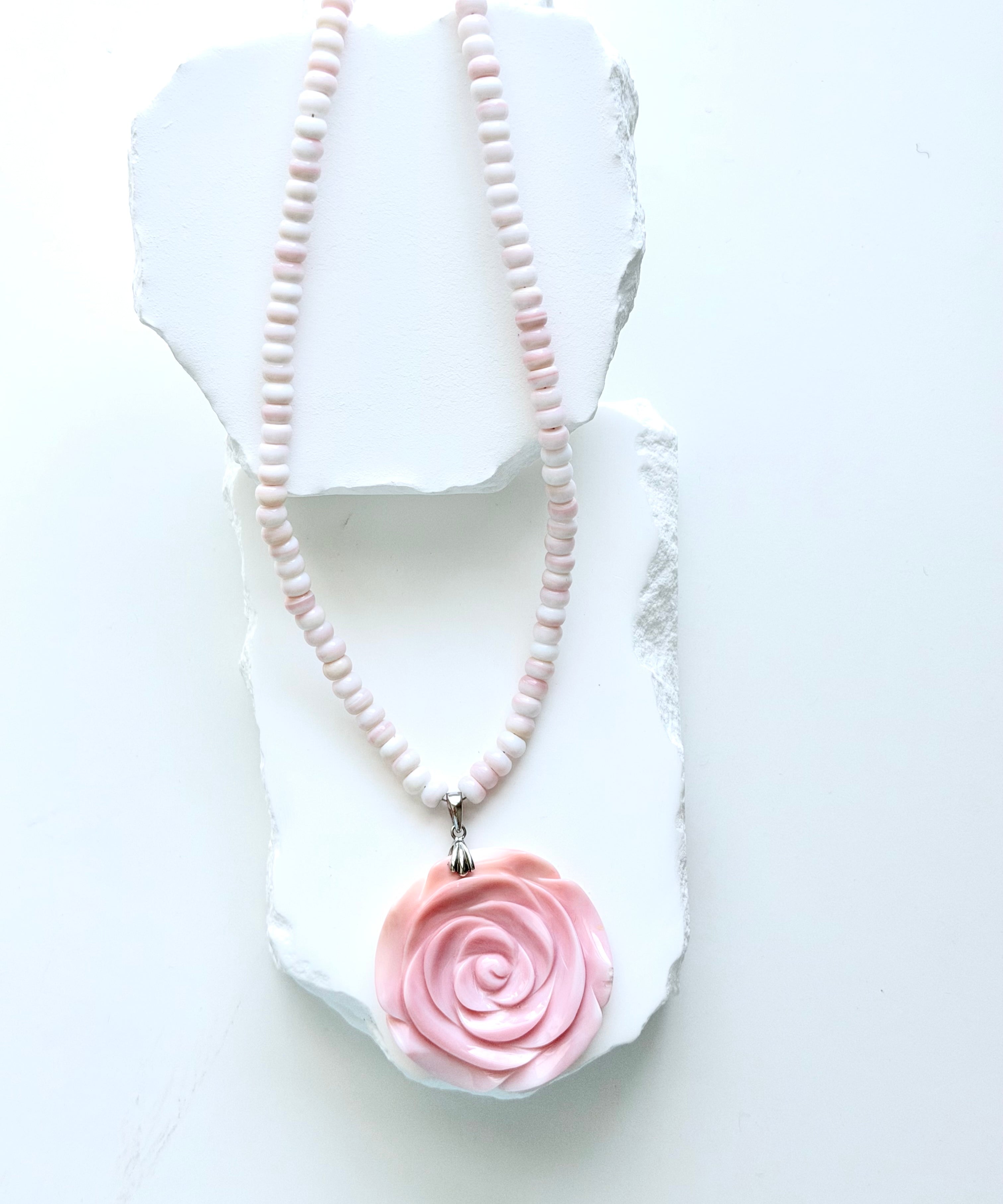 Limited-edition conch shell necklace with blush and ivory conch rondelles, hand-carved conch shell rose pendant, and silver detailing.