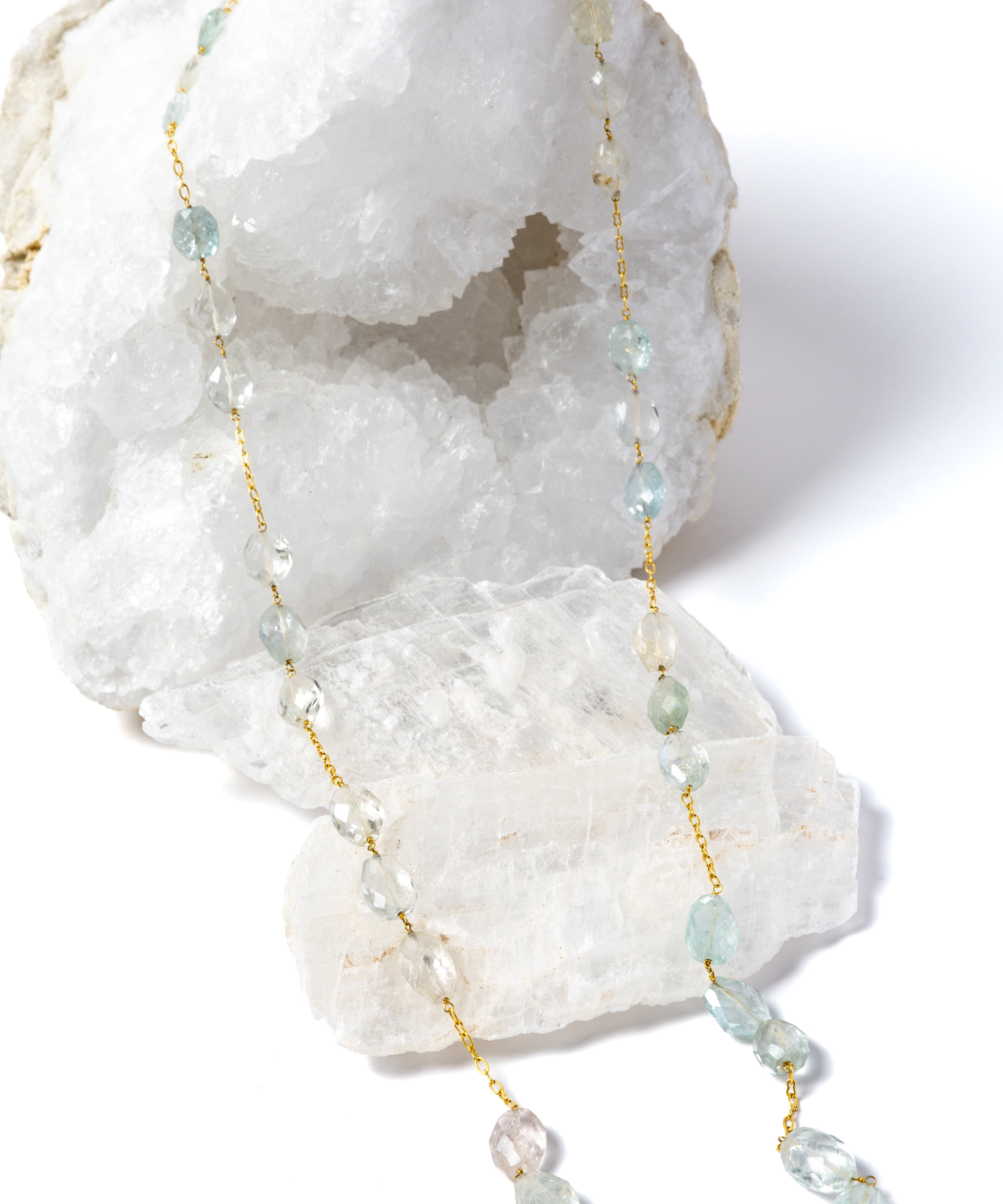 Serenity Mist long necklace featuring approximately 127 carats of natural faceted aquamarine gemstones set along a gold-plated chain in a graceful, fluid design.
